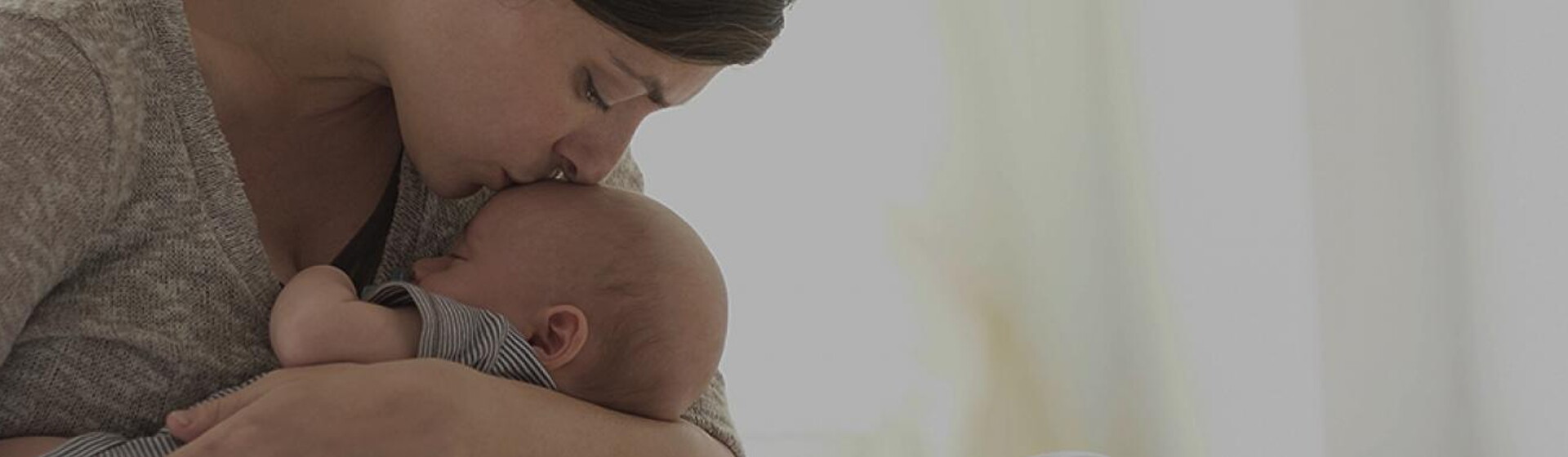 Mom kissing her baby